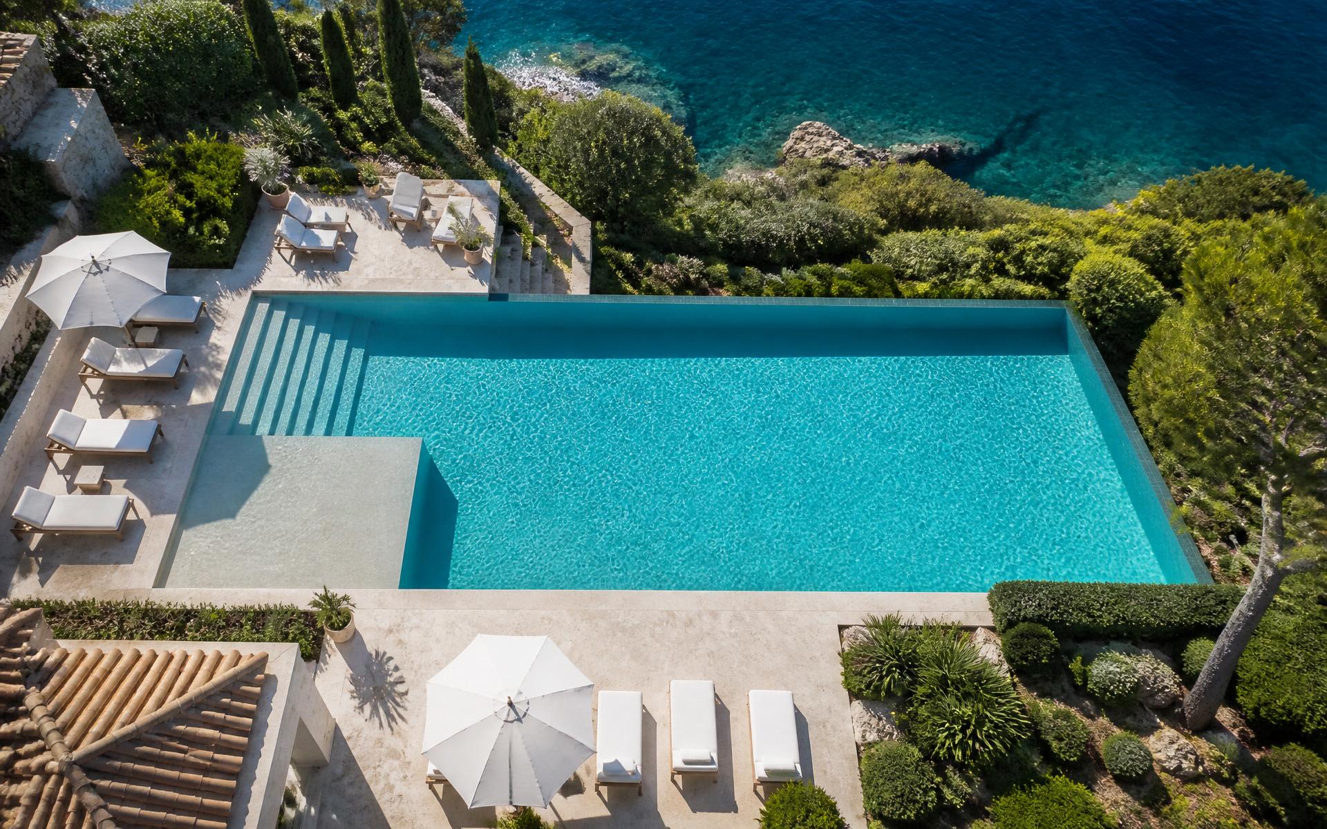 Aerial view of a pristine resort pool with turquoise water